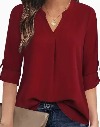 Women's V-neck blouse in burgundy, apricot, or black, featuring long sleeves and a relaxed fit.