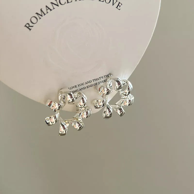 Trendy gold circle twists stud earrings for women, perfect for daily wear and parties.