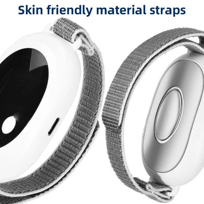 White handheld sleep aid remote control device with USB charging port on a bedside table.