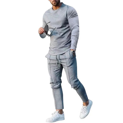 Men's light grey polyester two-piece suit set with long sleeve round neck T-shirt and matching trousers.