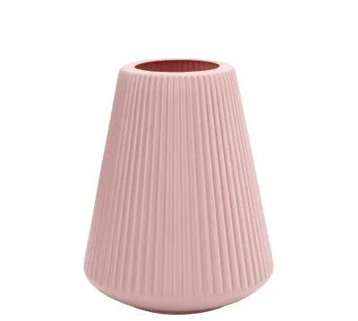 Melamine plastic decorative vase in blue colour measuring 16cm by 20cm on wooden desk