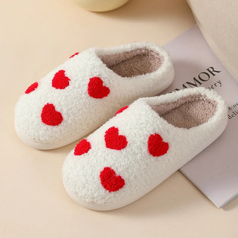 Women's plush home slippers in cartoon designs with a non-slip PVC sole.
