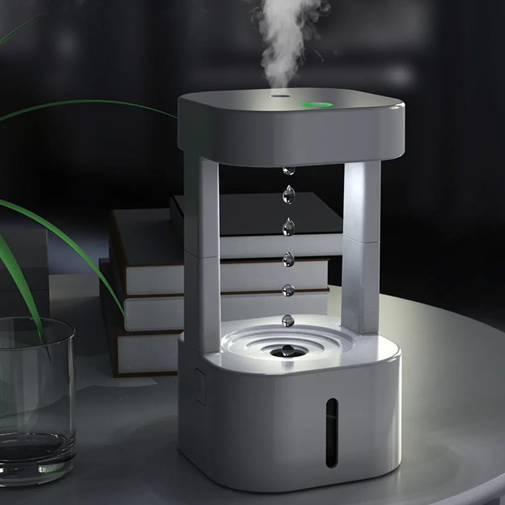 Creative anti-gravity water drop humidifier with upward flowing droplets and coloured lights