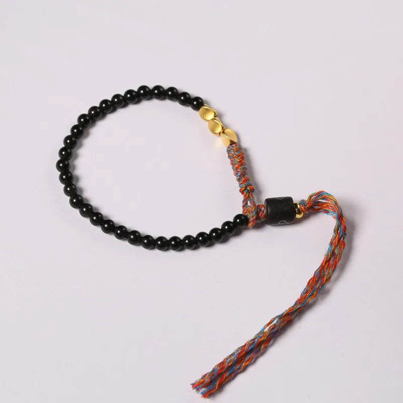 Hand-woven obsidian carrying strap showing woven texture and 4mm width