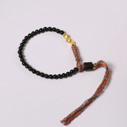 Hand-woven obsidian carrying strap showing woven texture and 4mm width
