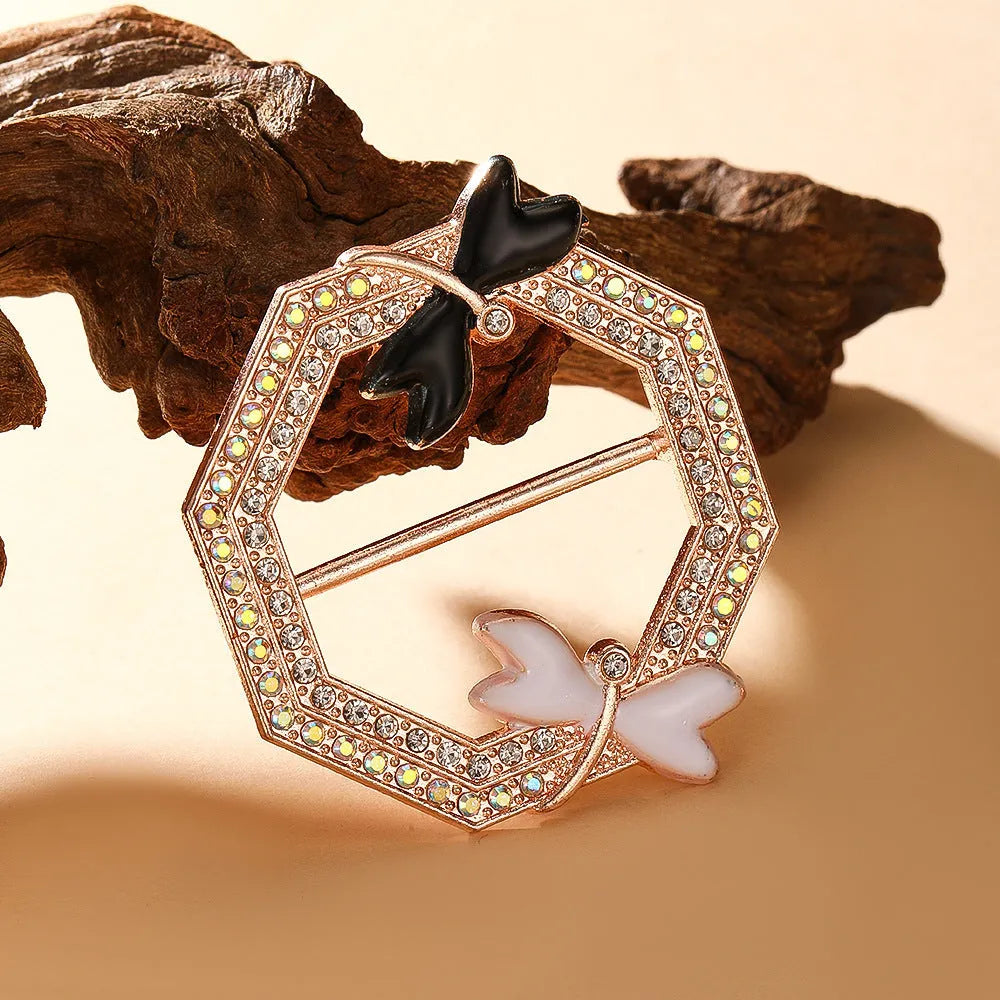 Bow-shaped waist-cinching accessory clip for high-end brooches, alloy with electroplating and diamond inlay, shown in gold, silver, or rose gold finishes.