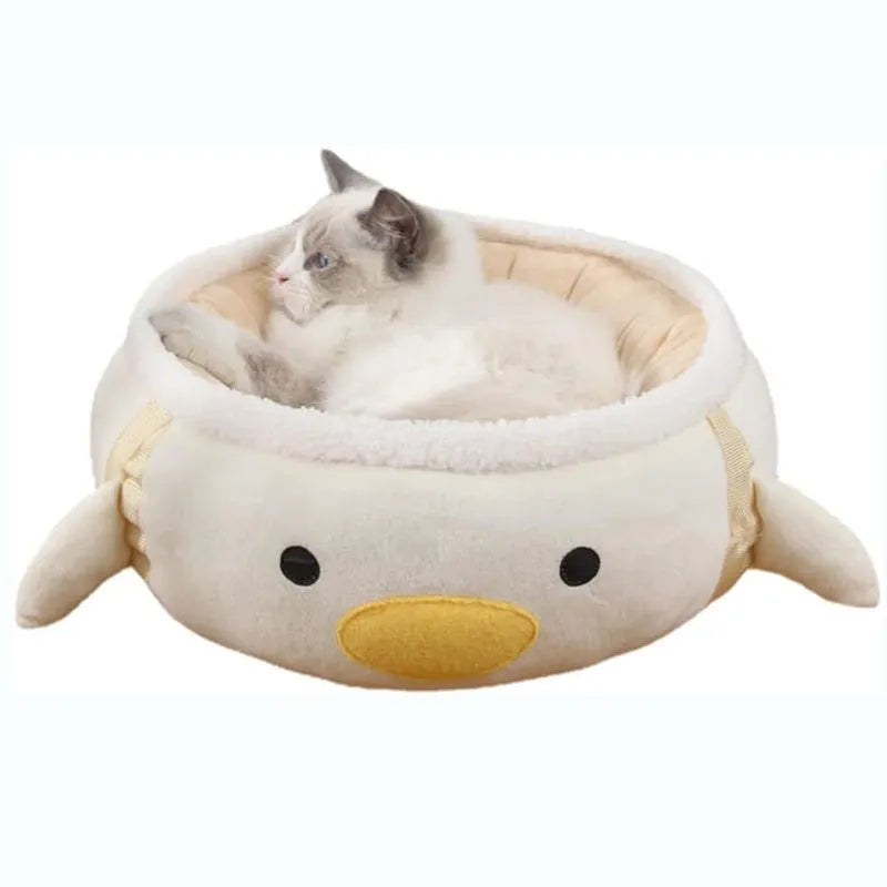 Green chick-shaped cat bed laid flat with hanging straps attached, suitable for small cats