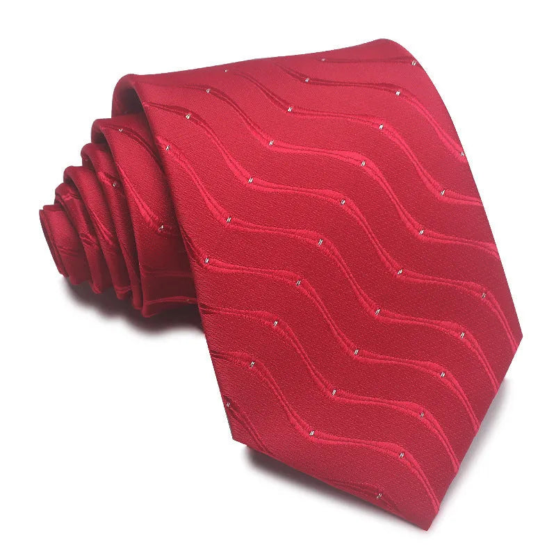 Close-up of a red and black striped jacquard weave tie with an arrow tip, showing texture.