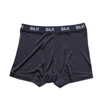 Men's loose-fitting silk shorts in navy blue on a neutral background.