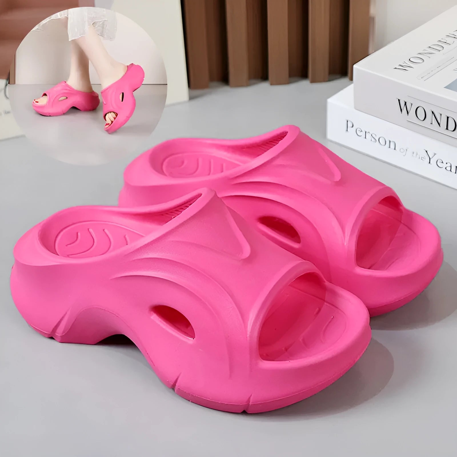 Women's thick-soled EVA foam beach slippers in rose red colour on a sandy background.