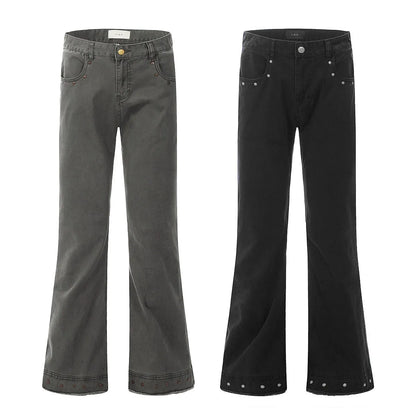 Pair of black straight-leg skinny jeans with a mid-rise waist and zipper fly on a neutral background.