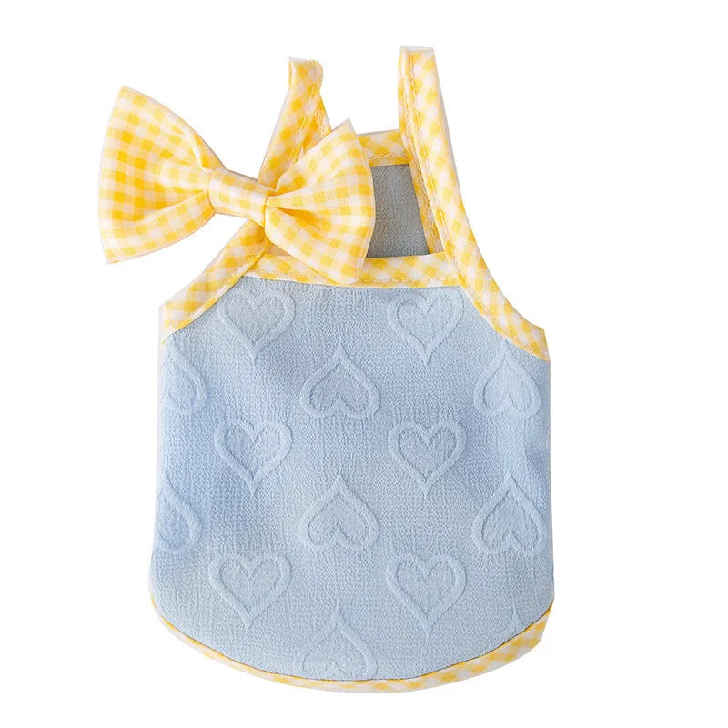 Small dog wearing blue elastic vest with suspenders and bow detail, showing stretch fit