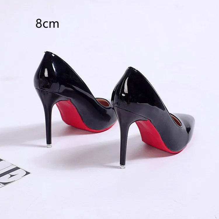 Women's black stiletto heel pumps with pointed toe and shallow mouth design on a neutral background