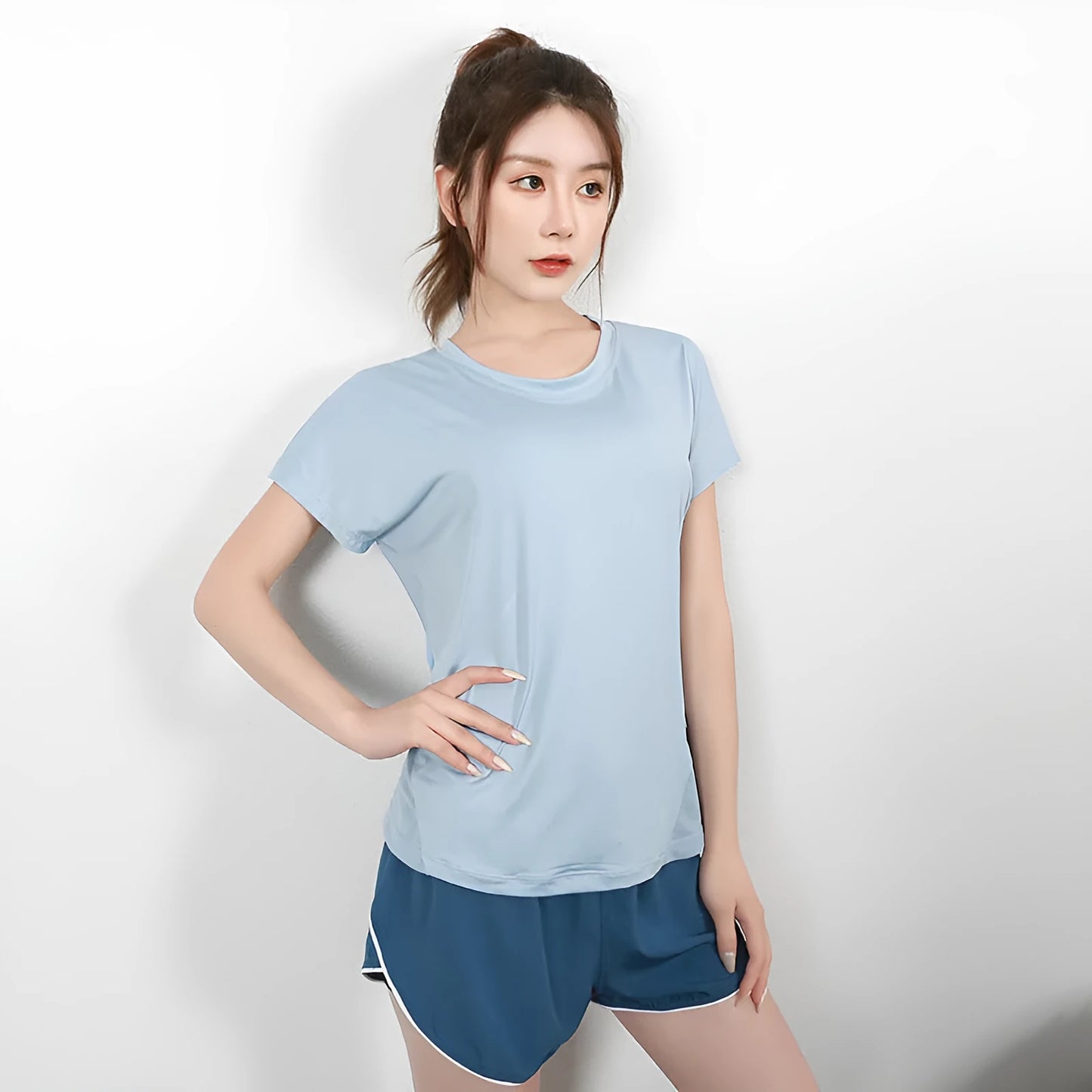 Women's pink short sleeve polyester sports T-shirt for fitness and running.