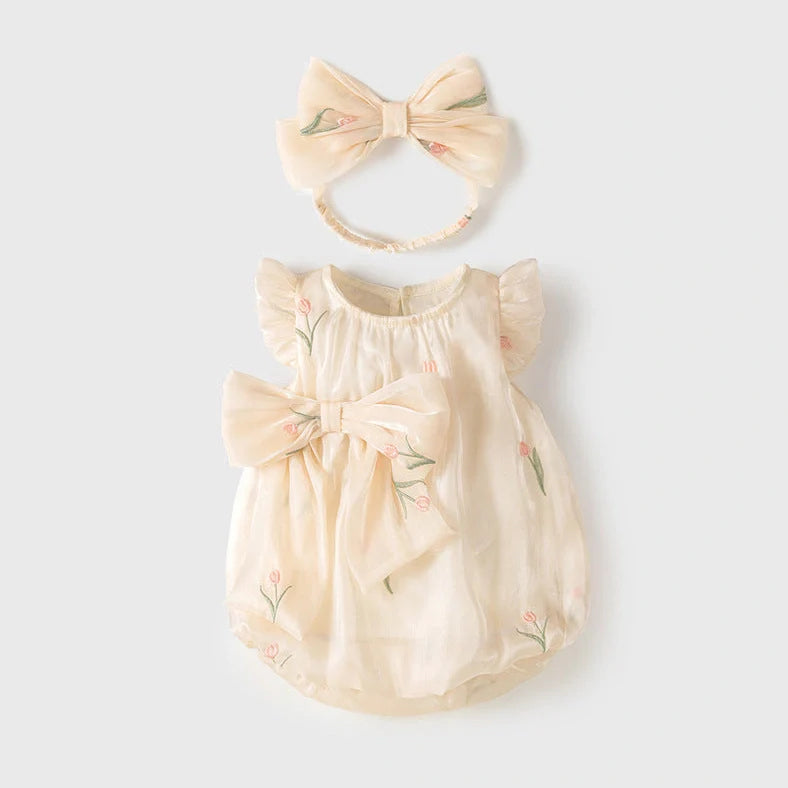 Apricot-coloured sleeveless baby jumpsuit with triangle design on hanger