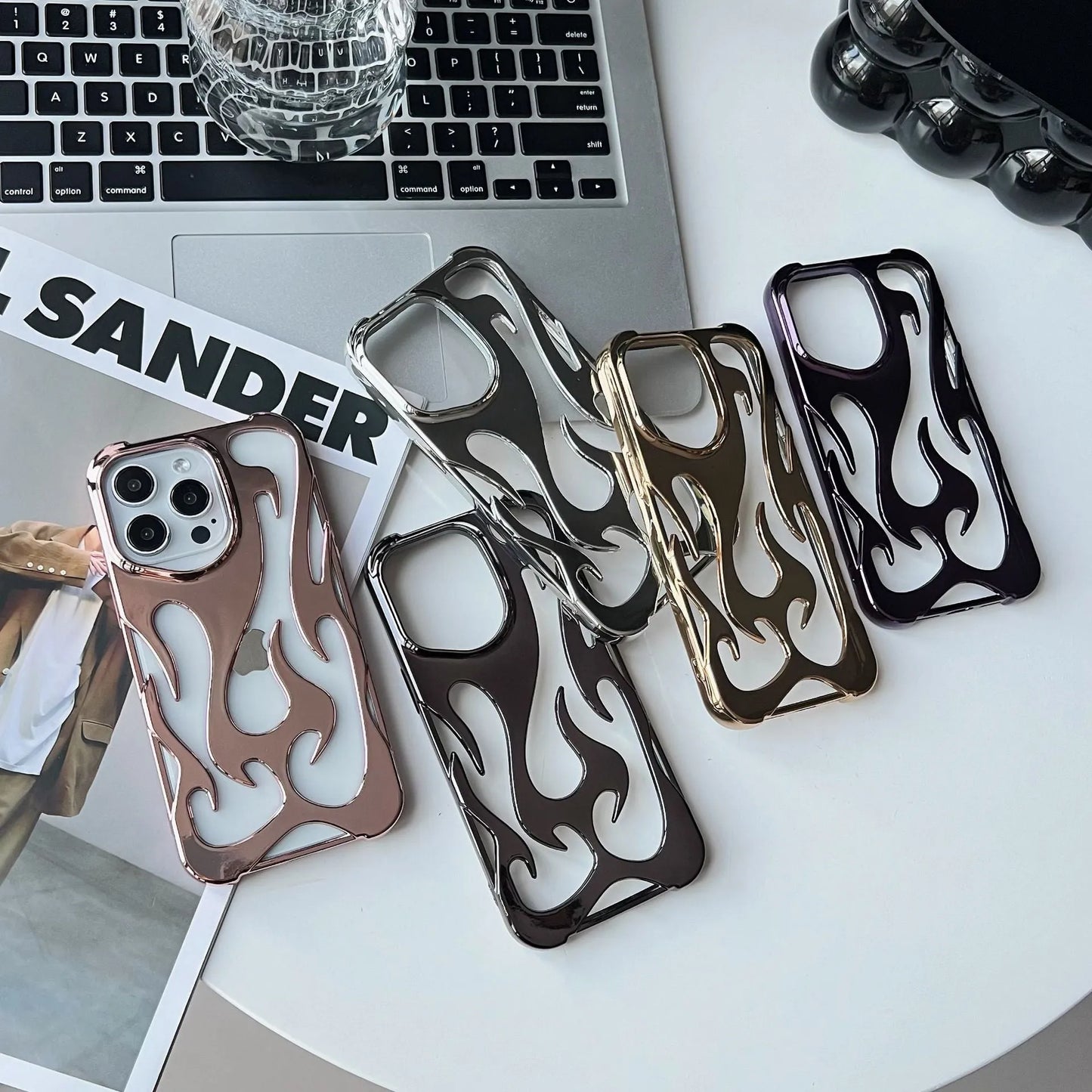 Electroplated hollow flame pattern phone case in silver plated finish on Apple iPhone, showing heat dissipation design and TPU soft shell