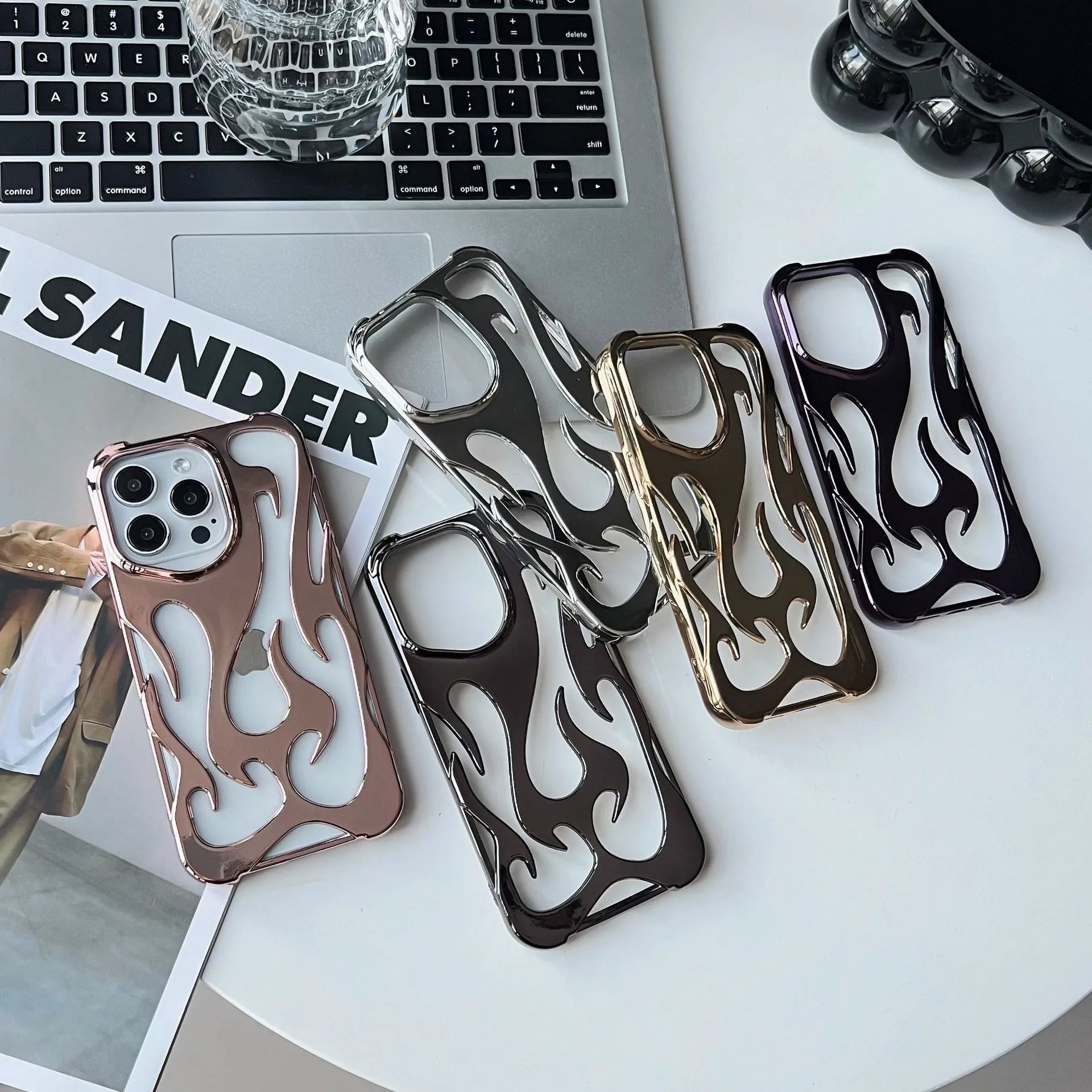 Electroplated hollow flame pattern phone case in silver plated finish on Apple iPhone, showing heat dissipation design and TPU soft shell