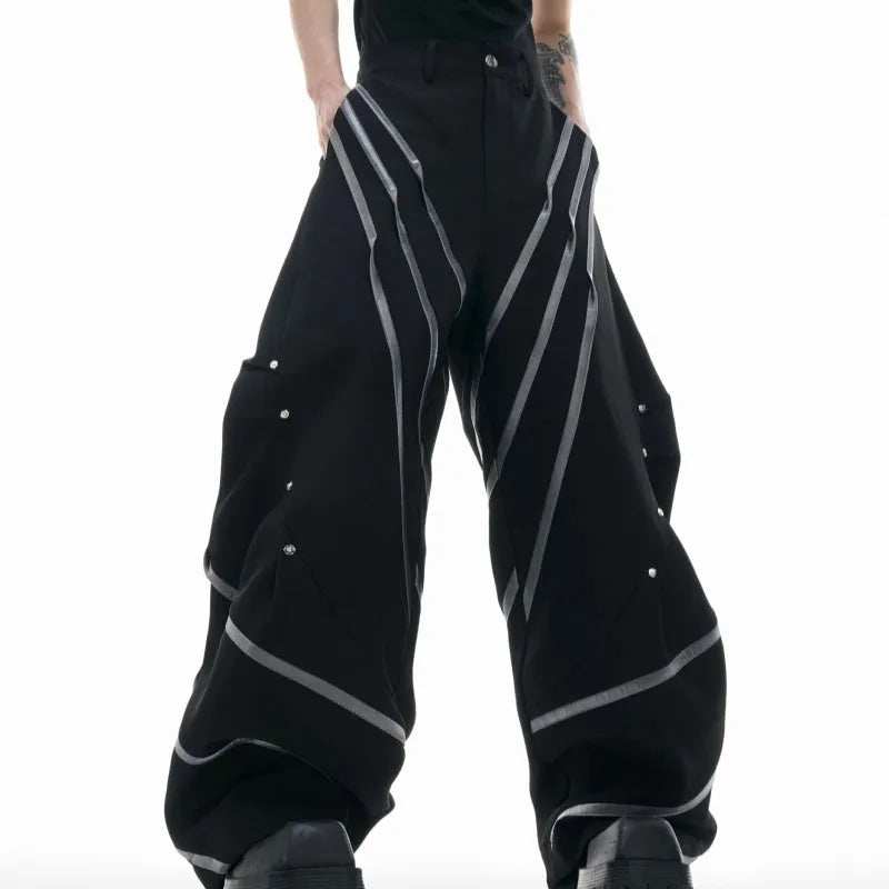 Men's trousers with three-dimensional cutting and metal striped rivet pleats in black or white, showing tailored fit and detail