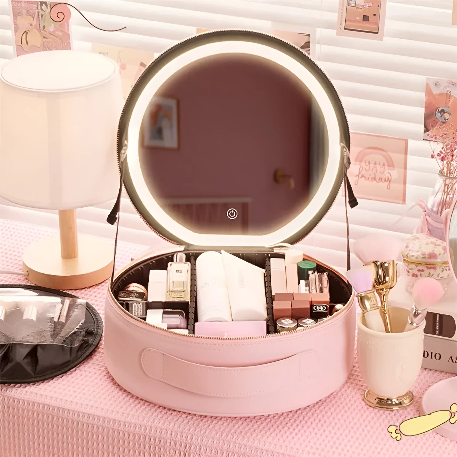 Round black LED light makeup bag with built-in mirror, carry strap, and open compartment showing internal partitions.