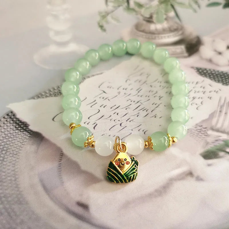 Chinese style glass bead bracelet with bamboo joint design on wrist.