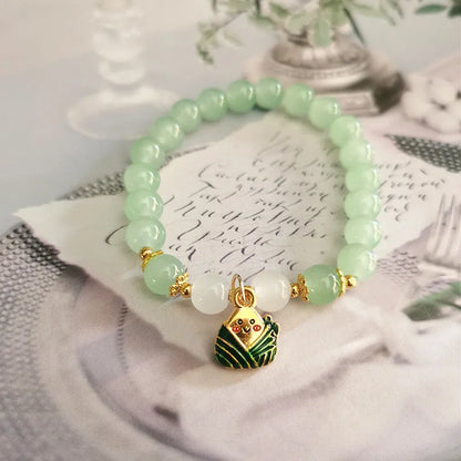 Chinese style glass bead bracelet with bamboo joint design on wrist.
