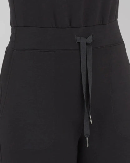 Women's lace-up jumpsuit pants in polyester, available in multiple colors and sizes for adjustable fit.