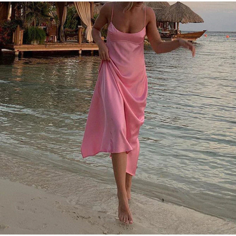Elegant satin slip dress in pink with a flattering, form-fitting silhouette and sexy backless design