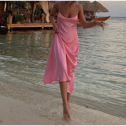 Elegant satin slip dress in pink with a flattering, form-fitting silhouette and sexy backless design