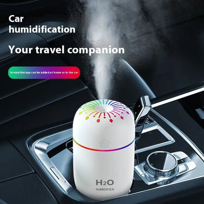 White USB mini humidifier with 300ml tank on desk beside laptop showing compact 75x75x116mm size