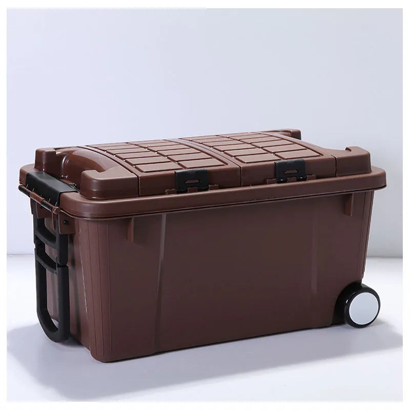 Large orange plastic storage box with black wheels and a pull-up handle, shown in a garage setting.