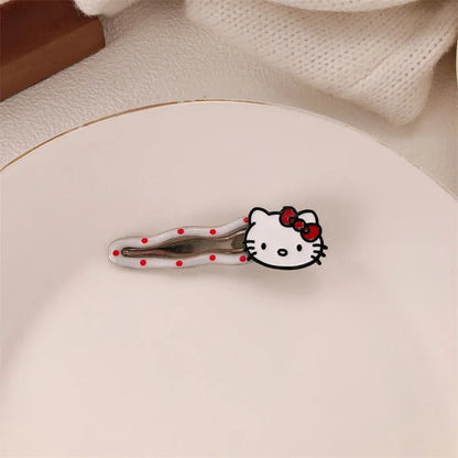 Red plastic hair clip with a 3D love heart and dots on a willow leaf-shaped base.