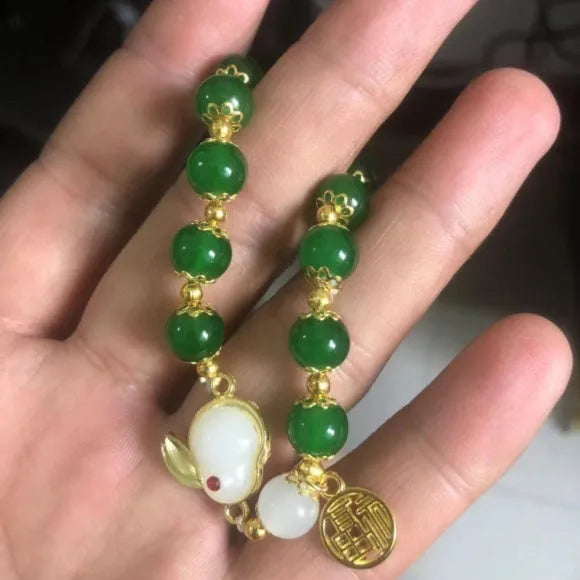 Chinese style glass bead bracelet with bamboo joint design on wrist.