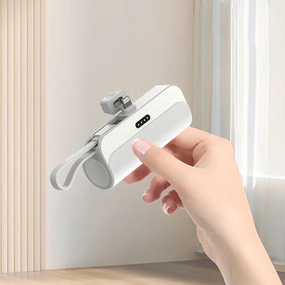 White capsule power bank showing compact 79mm size with USB charging ports visible