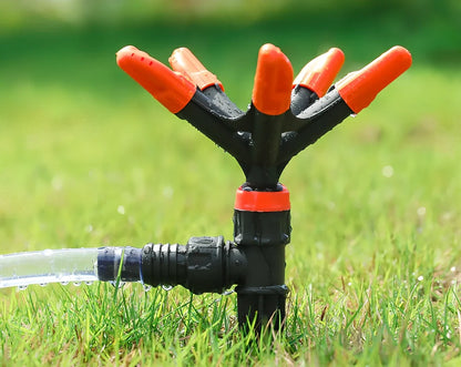 Orange automatic rotating garden sprinkler measuring 14cm diameter x 26.5cm height