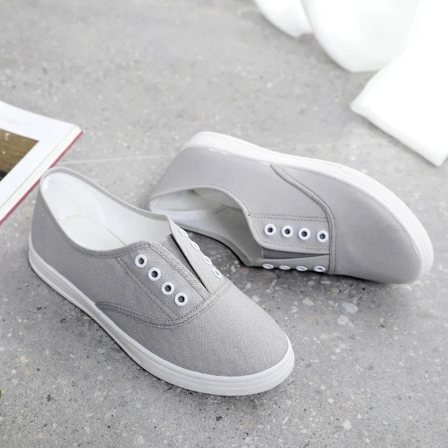 Low-top canvas casual shoes in various colours on a flat sole.