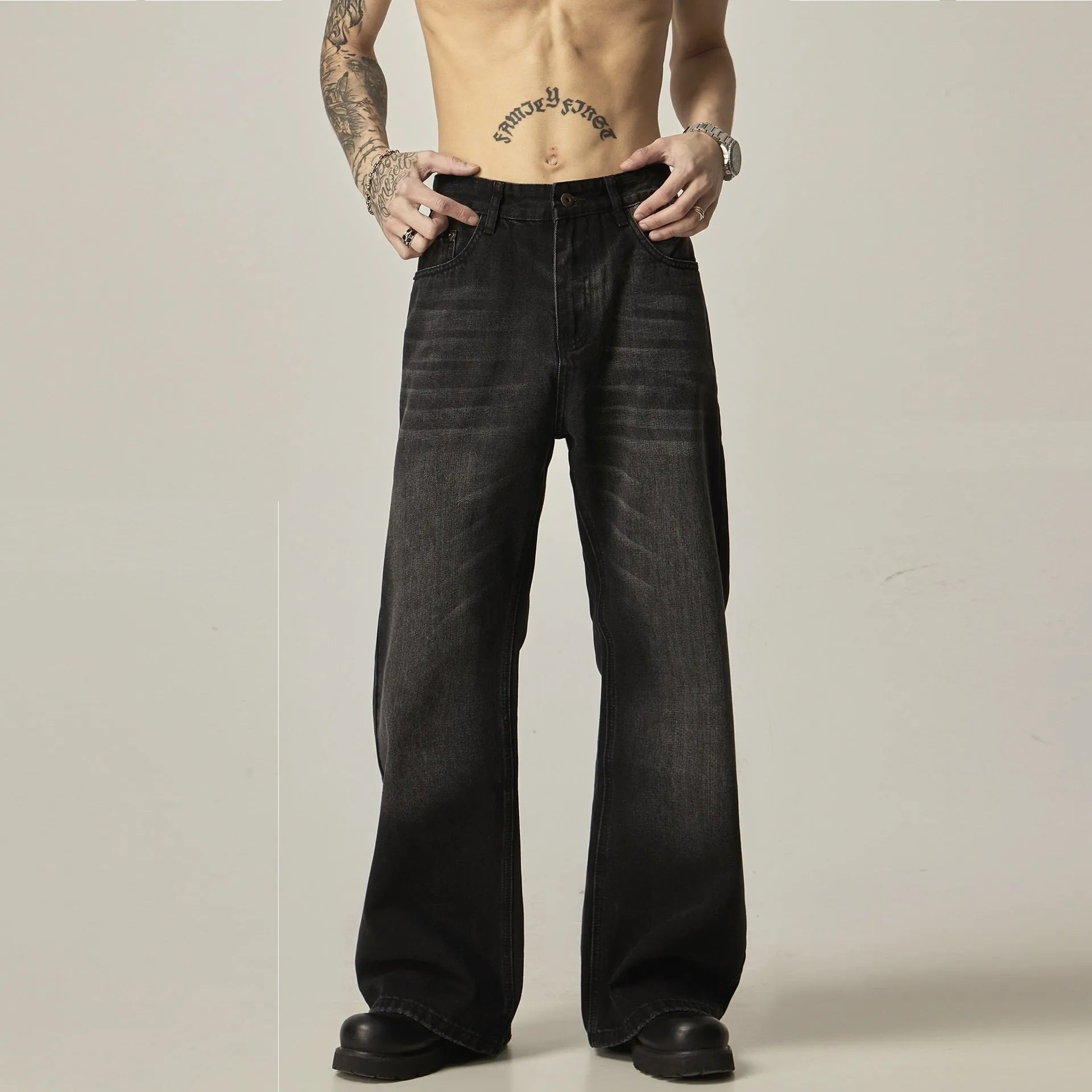 Black loose straight jeans with retro styling, zipper fly, and inelastic denim fabric