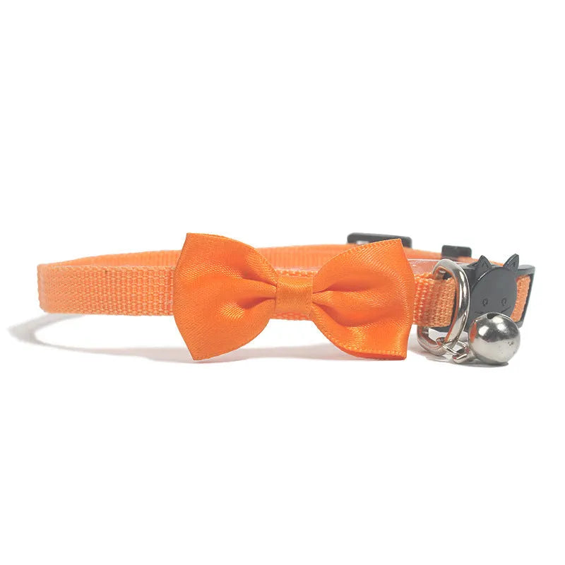 Striped nylon cat collar with decorative bow and bell in multiple colour options on a white background.