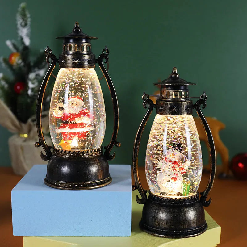Crystal ball Christmas decoration with LED-lit paper snowman and elderly figures on desktop
