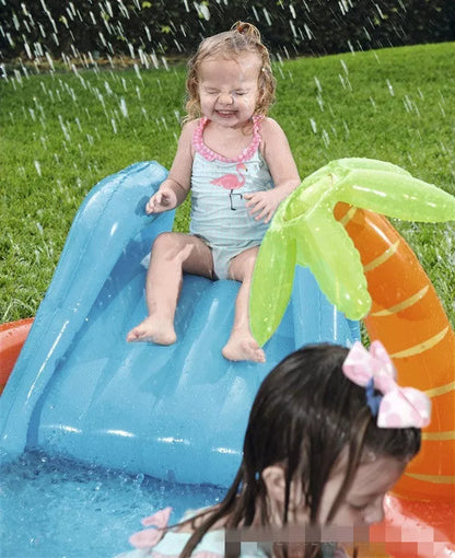 Children playing in an inflatable volcano-shaped pool with sprinkler and toys