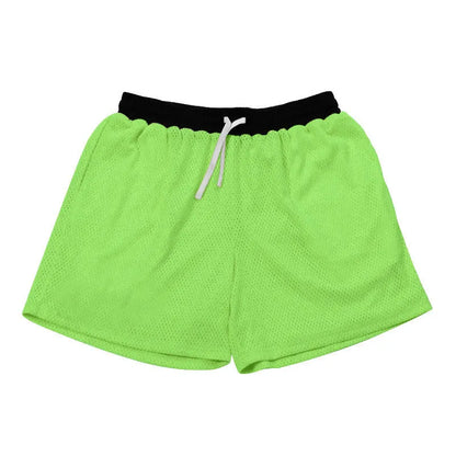 Men's black athletic shorts with grey mesh side panels for breathability, laid flat on a surface.