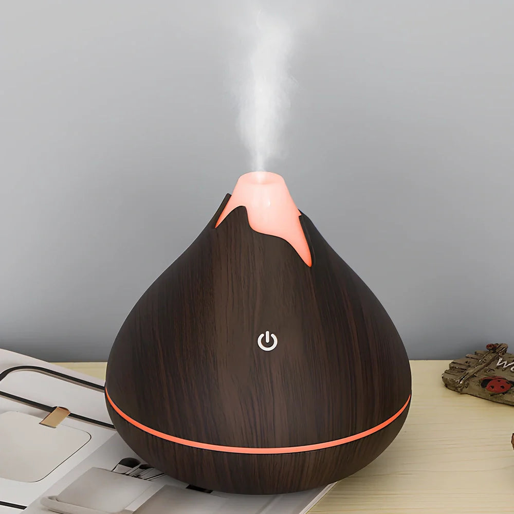 Round wood grain humidifier with USB cable and single mist outlet on light oak finish