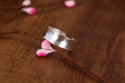 Geometric open sterling silver ring with frosted finish and adjustable gap.