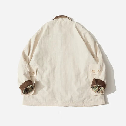Green and apricot unisex polyester casual jacket with side seam pockets on a hanger