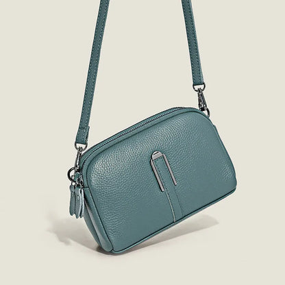 Minimalist top-grain leather crossbody bag in horizontal square shape with inner pockets, available in five colours