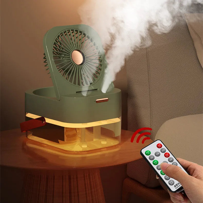 White or green USB desktop mist fan with large water tank, remote control, and dual spray nozzles on a desk.