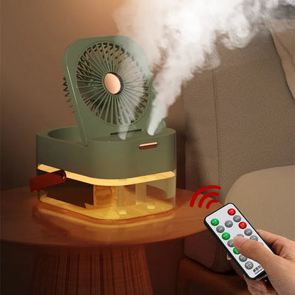 White or green USB desktop mist fan with large water tank, remote control, and dual spray nozzles on a desk.