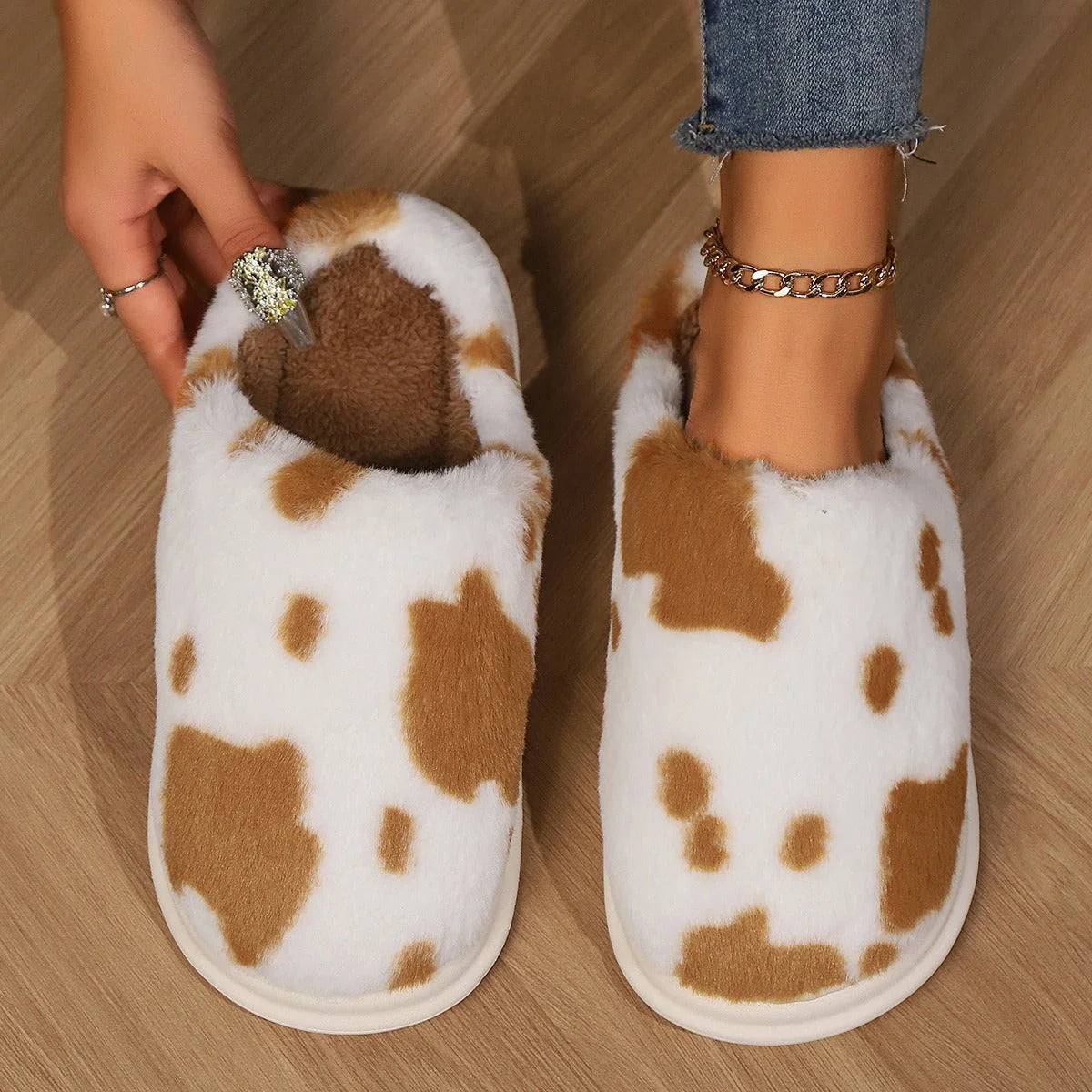 Cozy plush cow-print slippers with non-slip soles for comfortable indoor wear