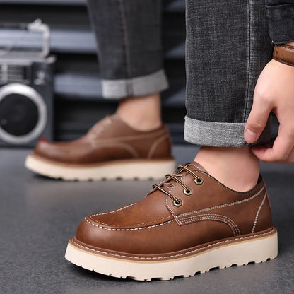 Men's black low-top Martin boots with a round toe and rubber sole on a white background.