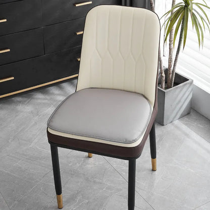 Leather horseshoe-shaped seat cushion in beige colour on a chair, showing non-slip base and 2.5cm thickness.