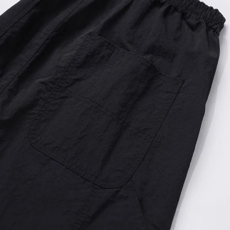 Black tooling paratrooper pants with elastic waist drawstring closure and baggy three-dimensional cutting